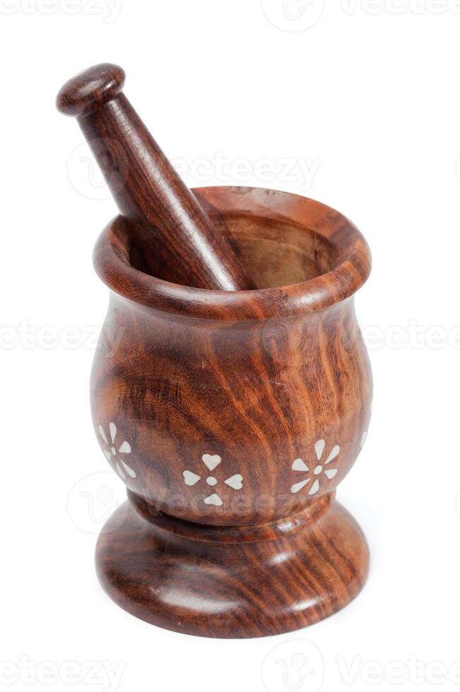 Wooden mortar and pestle isolated photo
