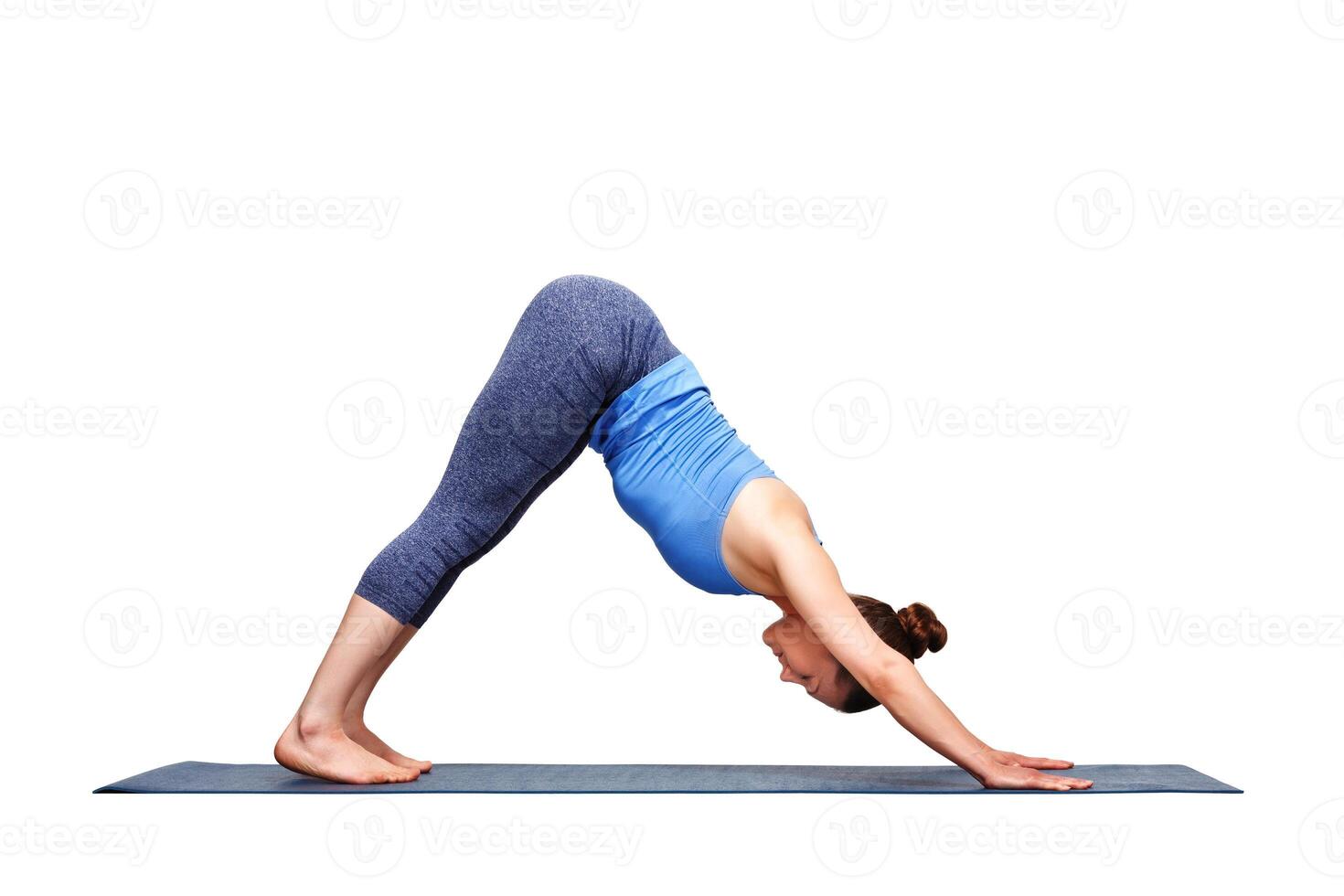 Beautiful sporty fit yogi girl practices yoga asana adhomukha sv photo