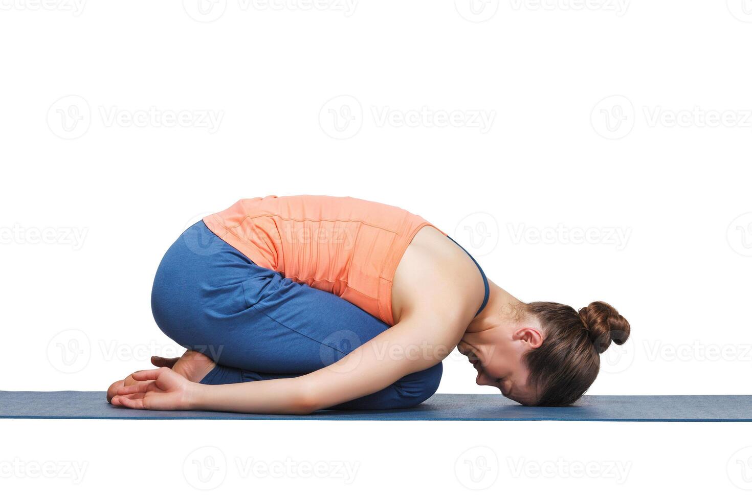 Beautiful sporty fit yogi girl practices yoga asana balasana photo