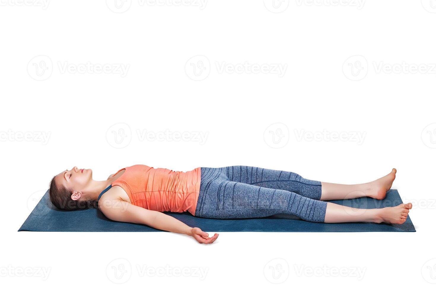 Beautiful sporty fit yogi girl relaxes in yoga asana Savasana photo