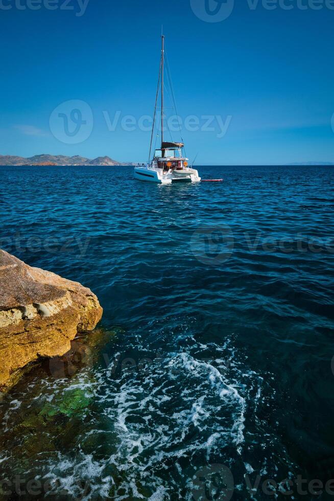 Yacht boat at Sarakiniko Beach in Aegean sea, Milos island , Greece photo