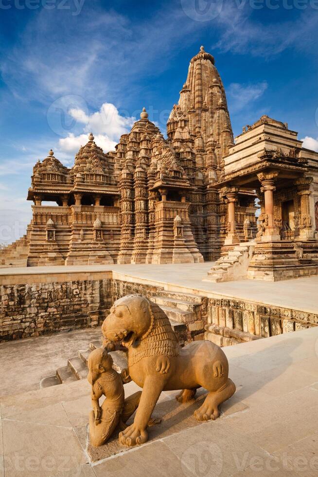 King and lion fight statue and Kandariya Mahadev temple photo