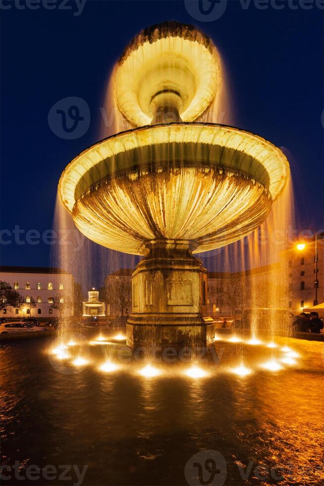 Fountain in the Geschwister-Scholl-Platz in the evening. Munich, photo