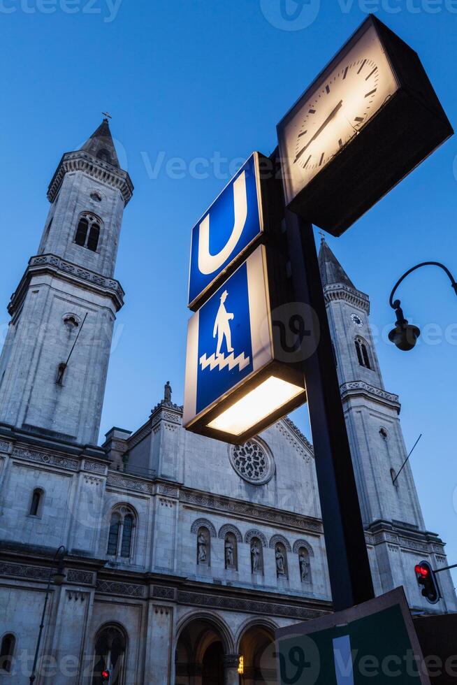 U Bahn sign and St. Ludwig's Church  Ludwigskirche in the eveni photo