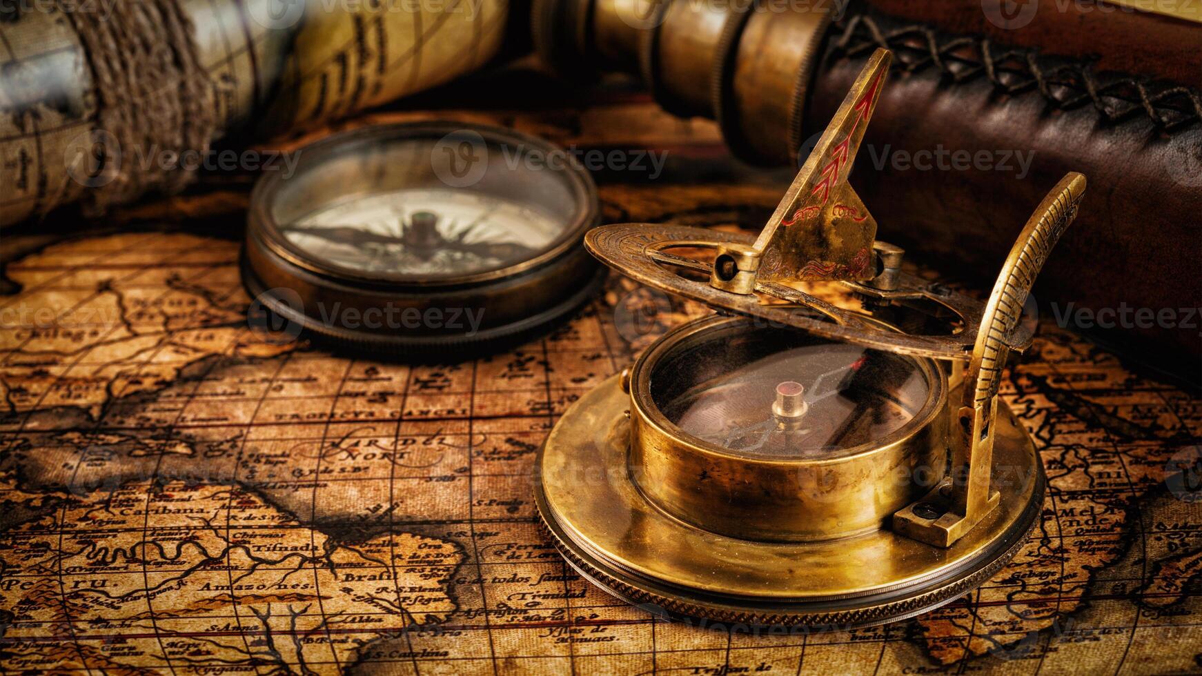 Old vintage compass on ancient map photo