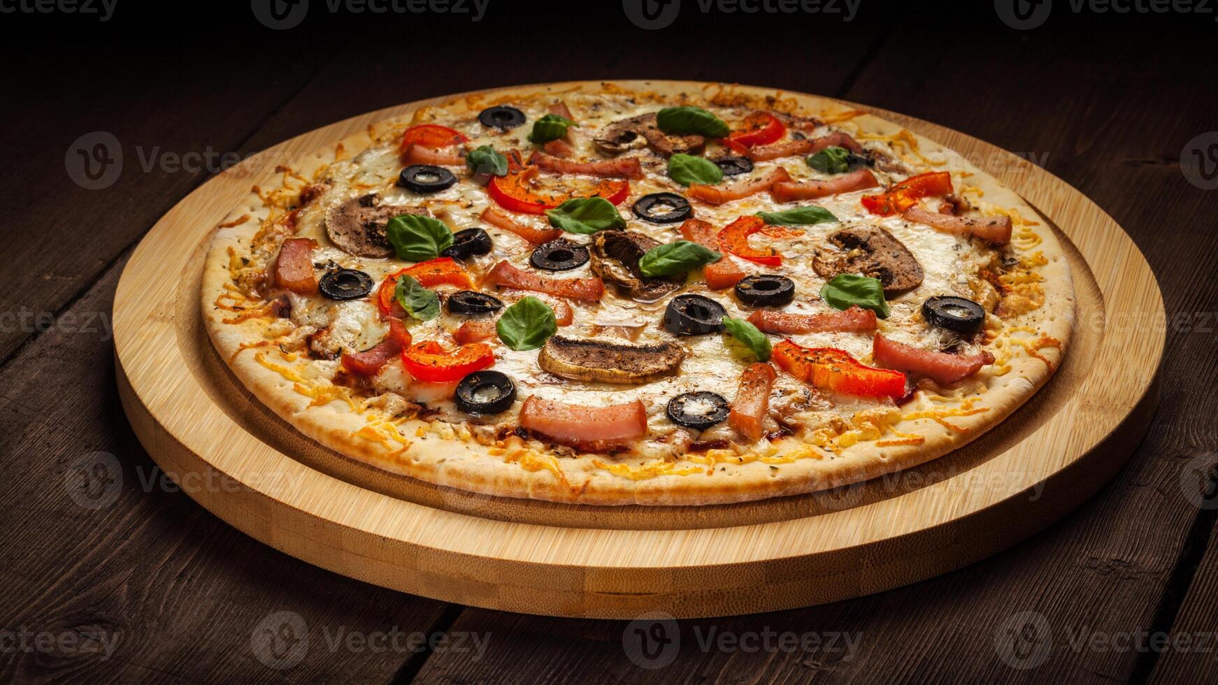 Ham pizza on wooden background photo