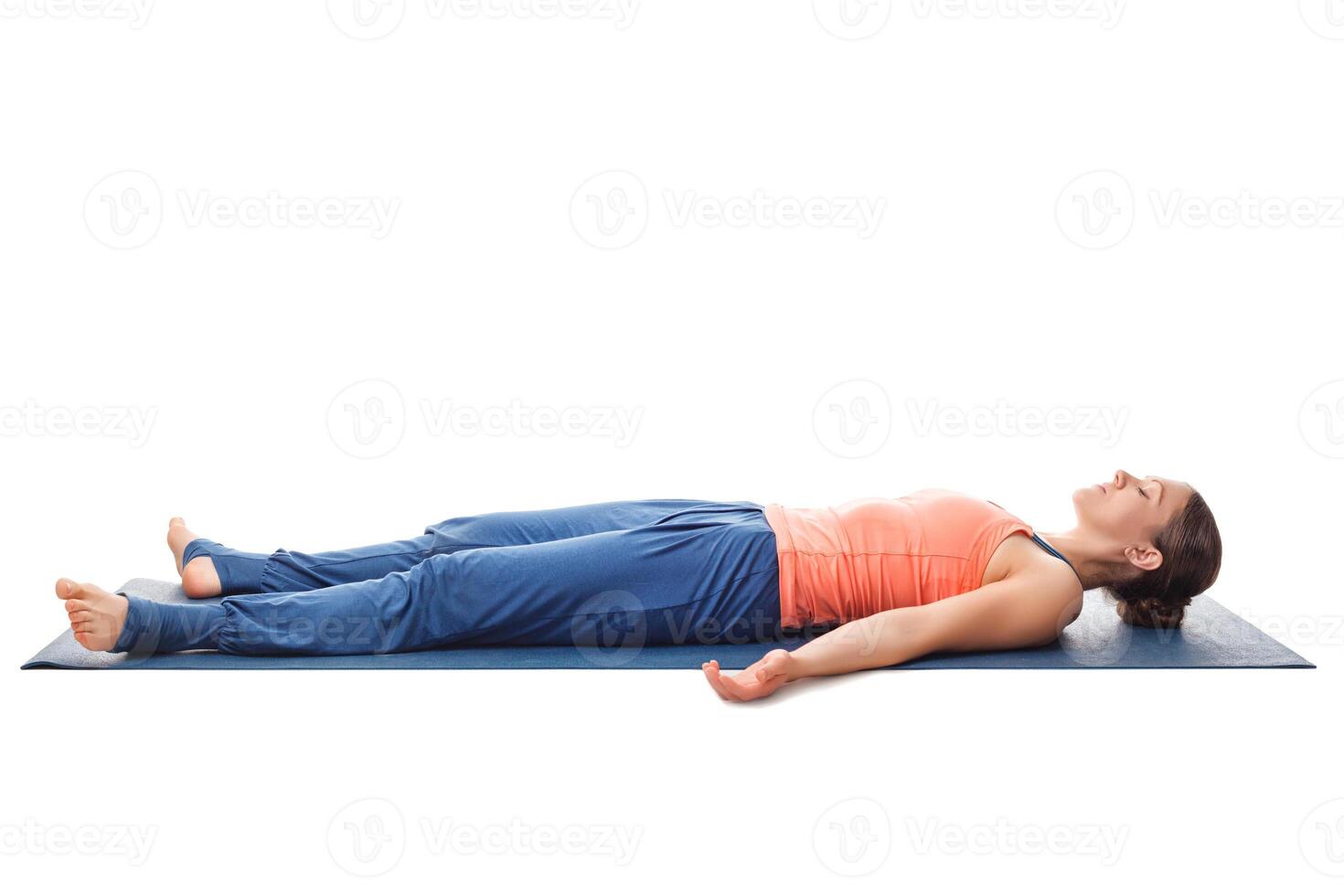 Sporty fit yogi girl relax in yoga asana Savasana photo