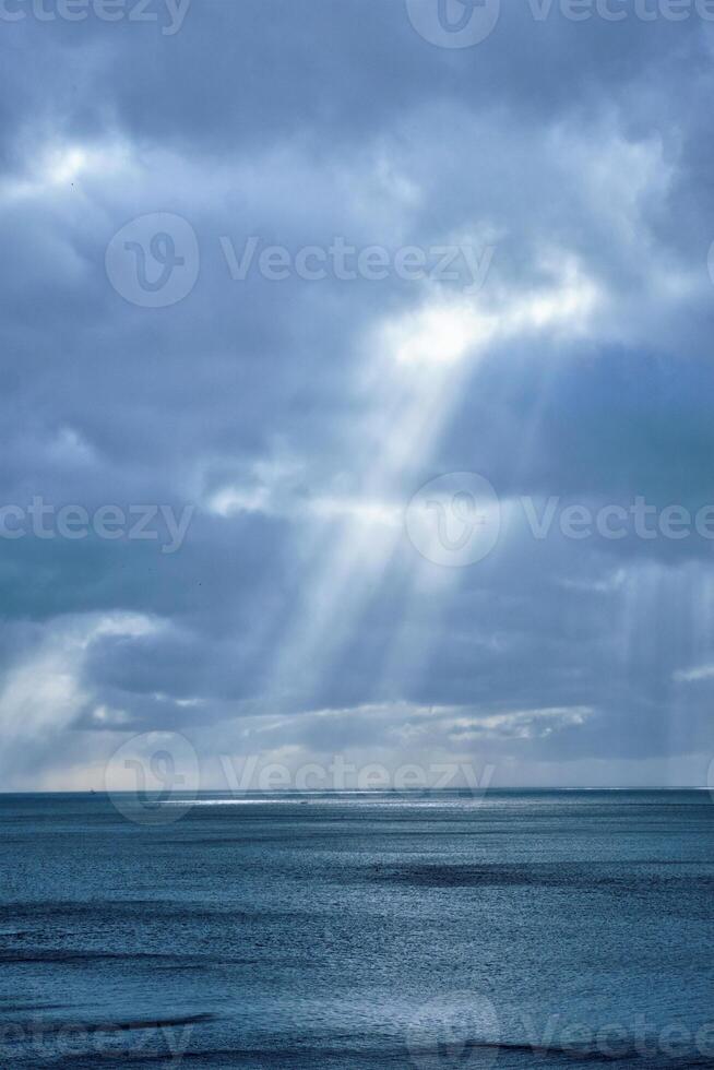 Norwegian sea in winter with sun rays photo