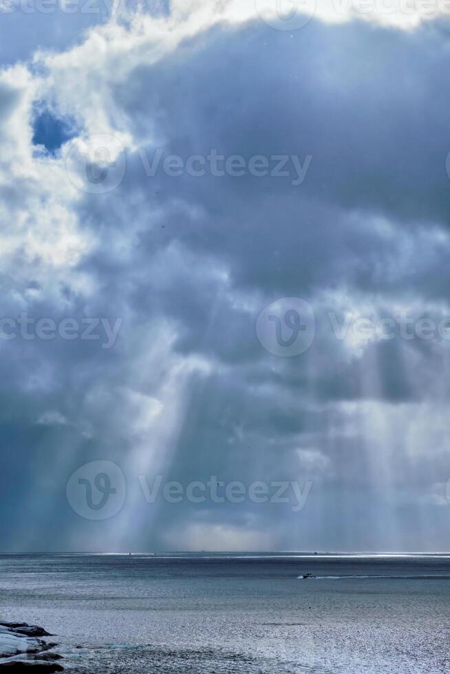 Norwegian sea in winter with sun rays photo