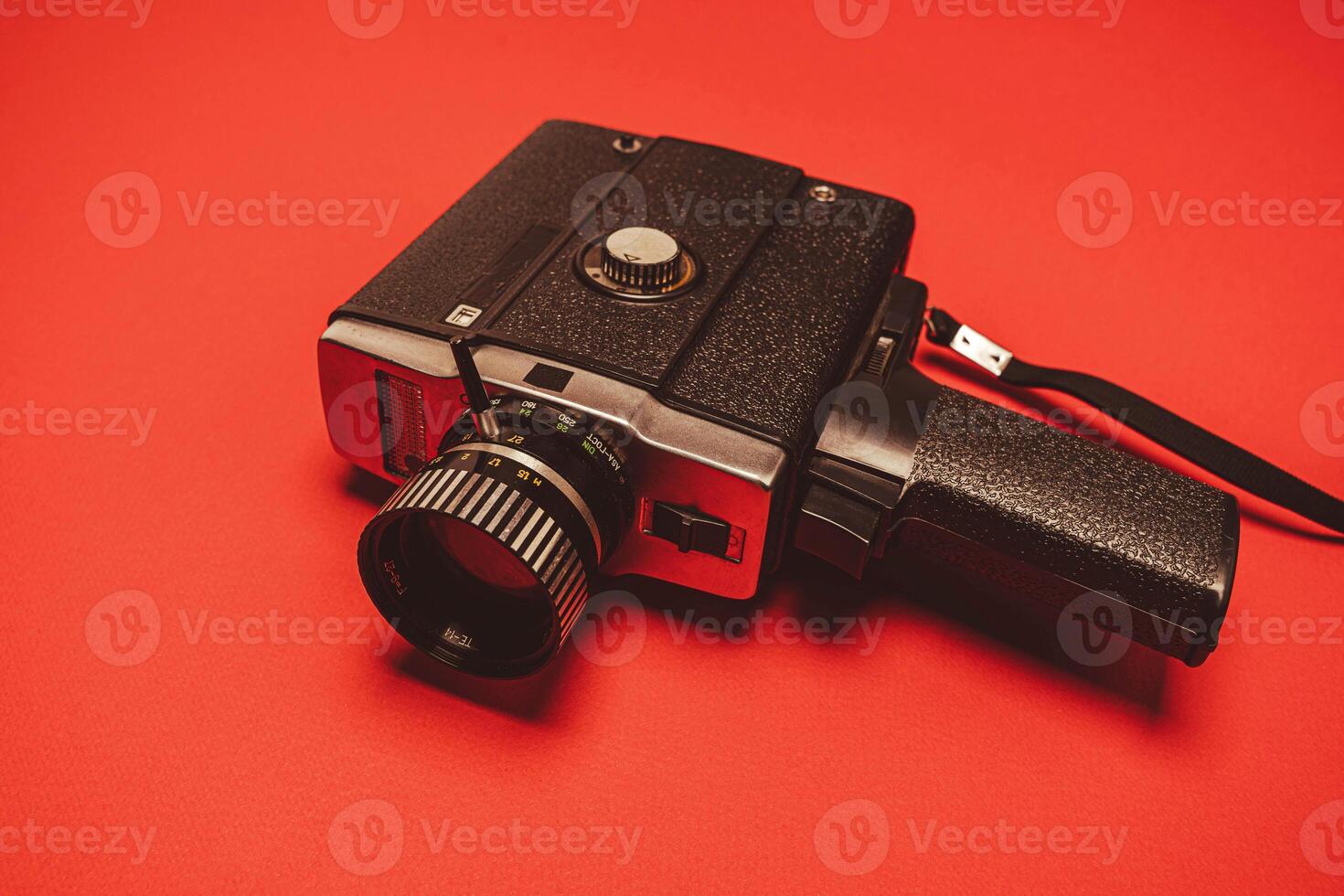 vintage portable movie camera on a red background. retro, 70s, 80s photo