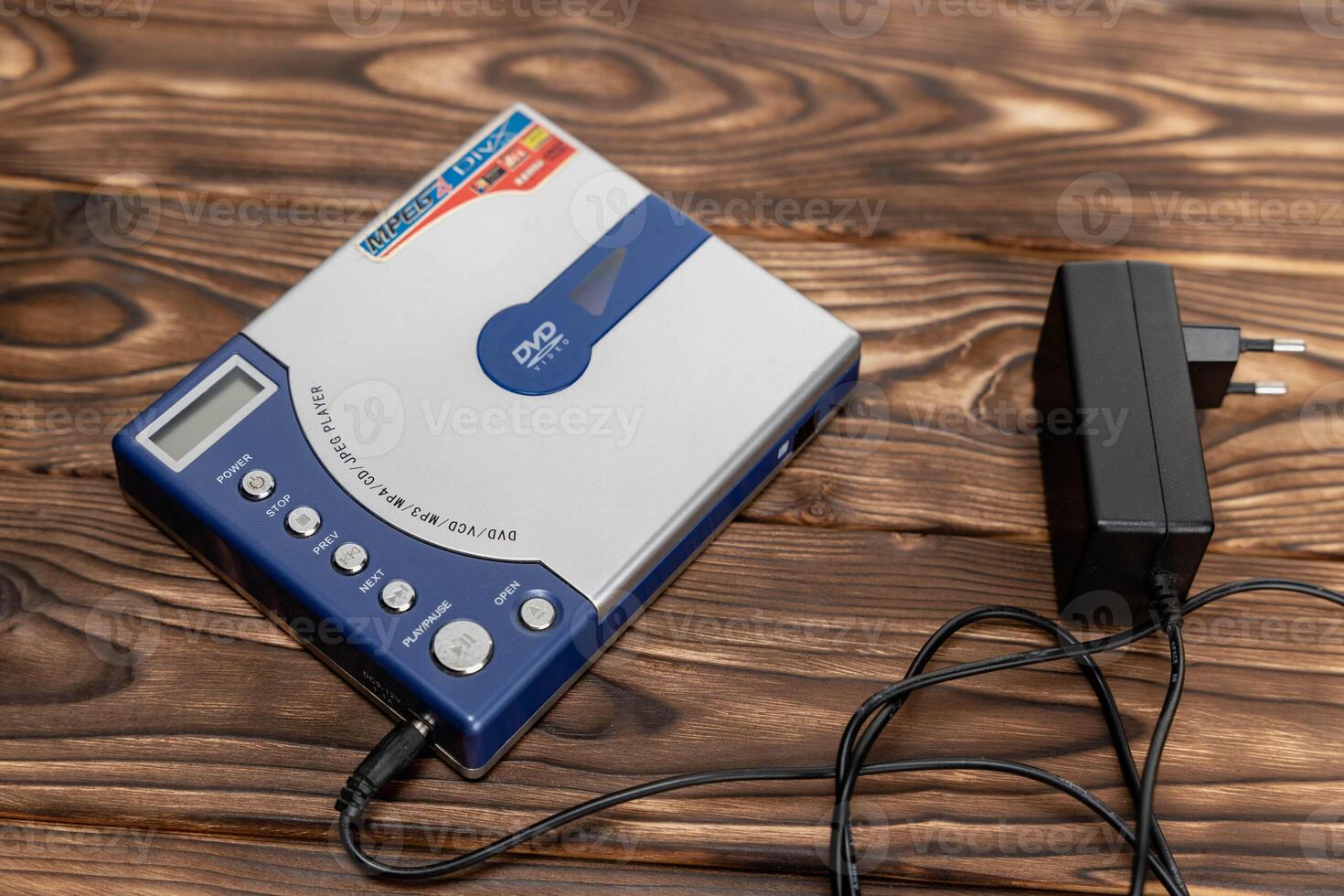 CD player or DVD player on a wooden background. control buttons. Power unit photo