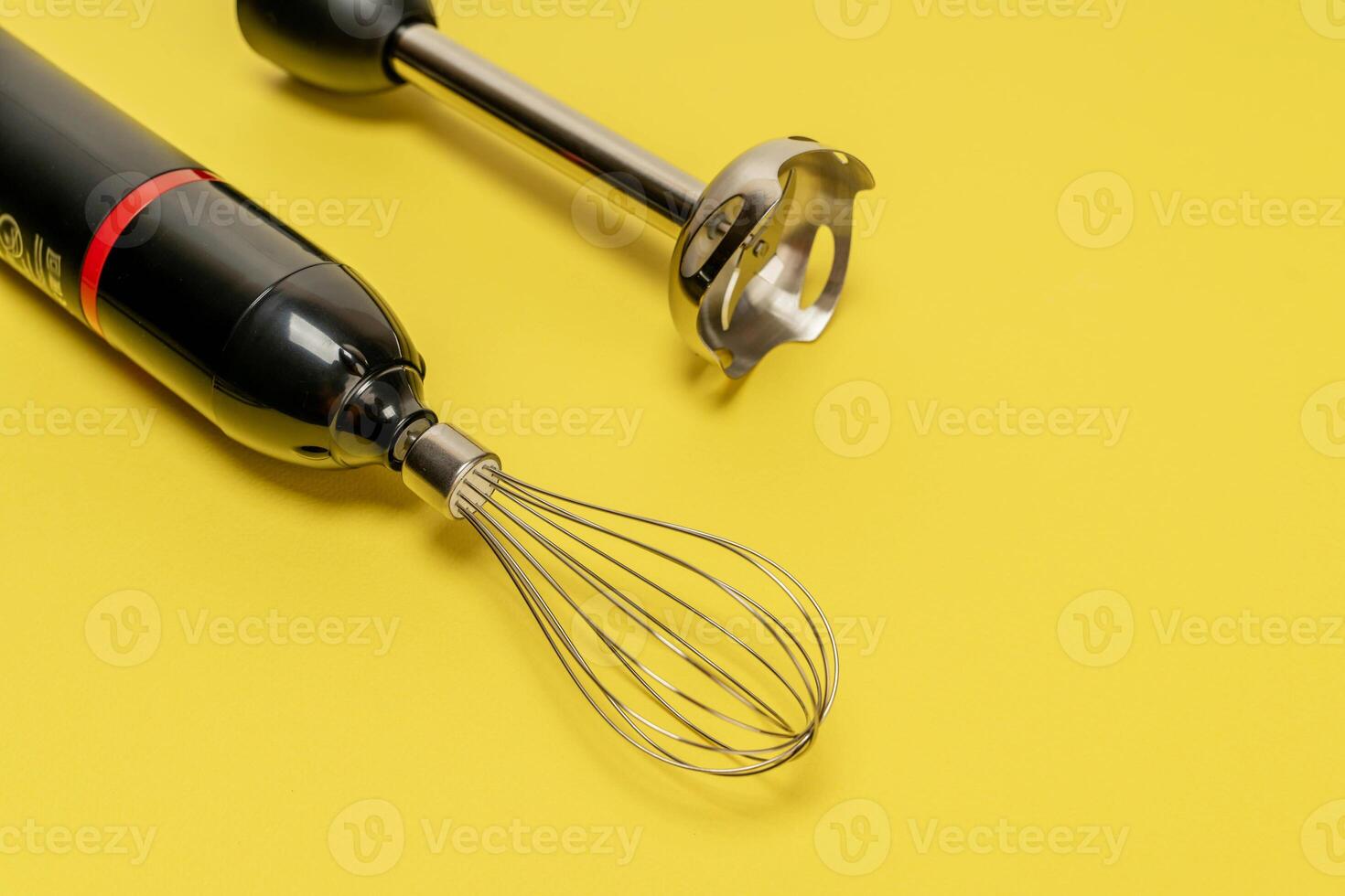 Whisk and Whisk Attachment on Yellow Background photo