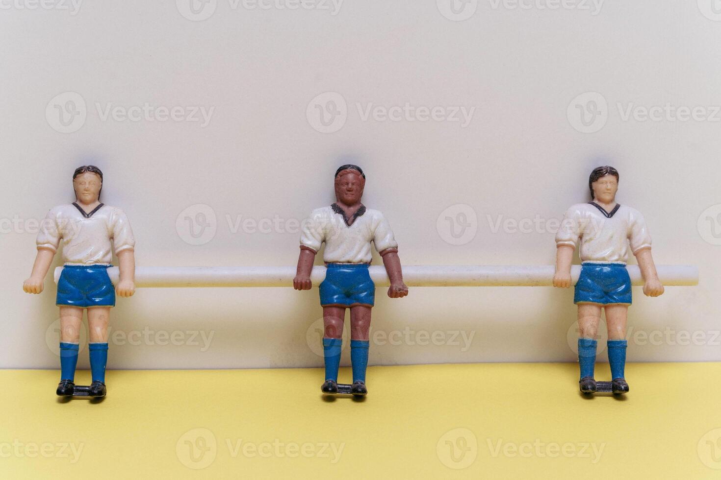 Three figurines of people,football players. mini football team, teamwork, sports photo