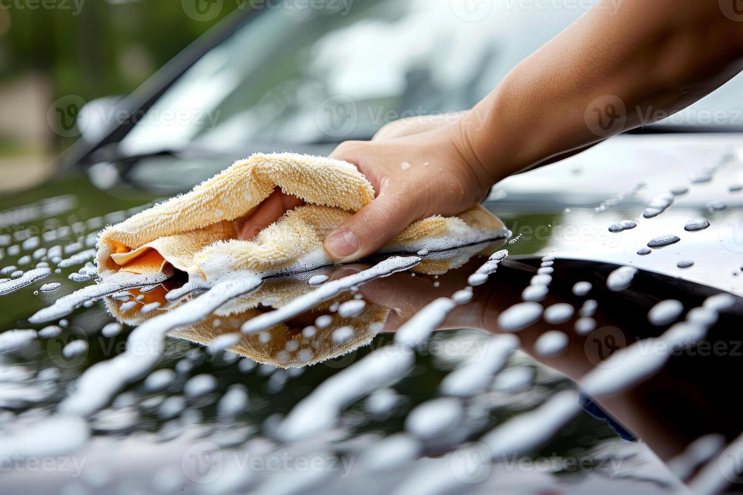 AI generated Close-up of a man's hand with a sponge with bubbles washing a car by hand photo