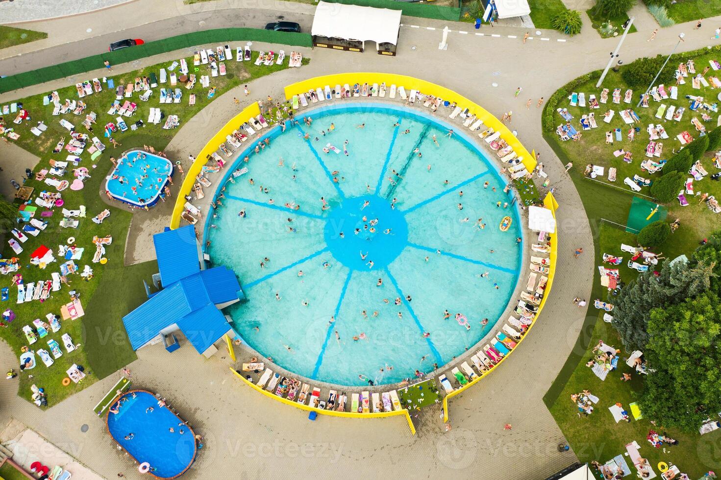 Top view of an outdoor place for people to relax where there is a swimming pool and a lot of sun beds photo