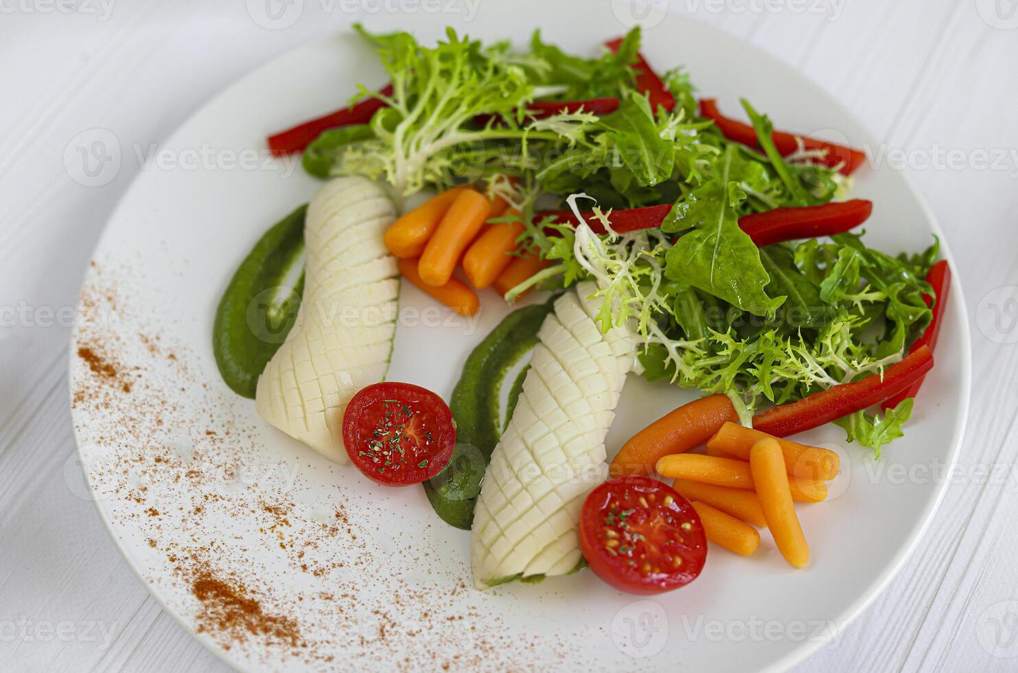 Boiled squid with baby carrots and lettuce, tomatoes and pea puree. Keto diet. photo
