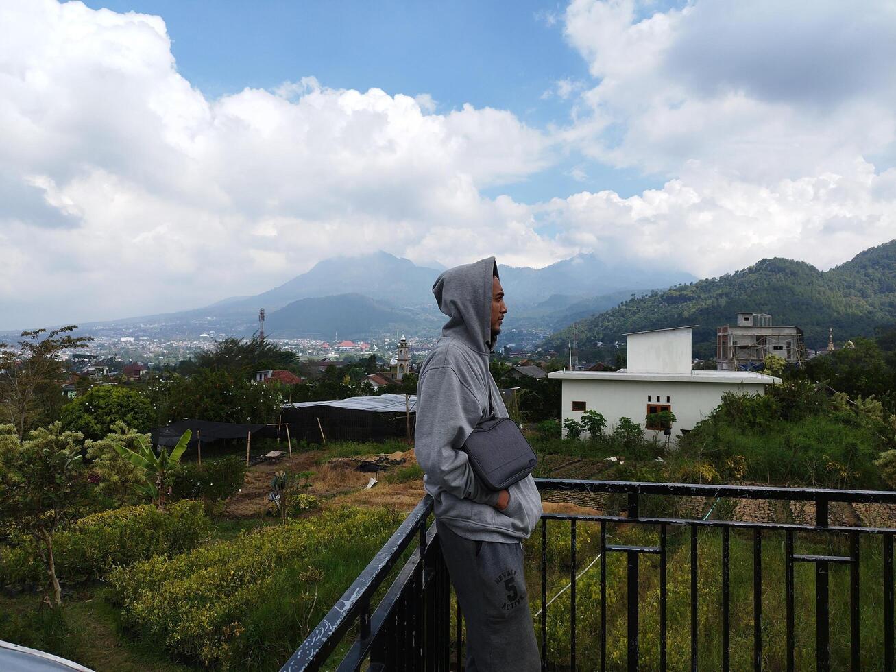 travas - mojokerto, Indonesia, julio 12, 2022 - un hombre es a un techo café con un ver de montar arjuna, este Java, Indonesia foto