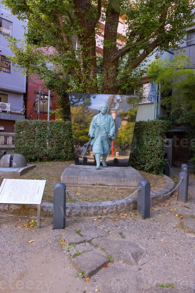 A Japanese stone statue at Tomioka Shrine with copyspace photo