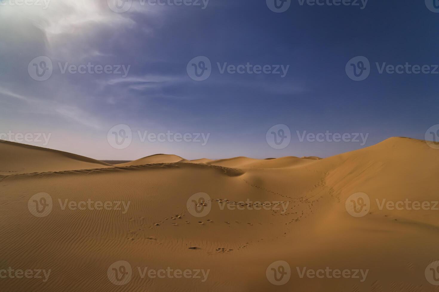 A panoramic sand dune of sahara desert at Mhamid el Ghizlane in Morocco wide shot photo