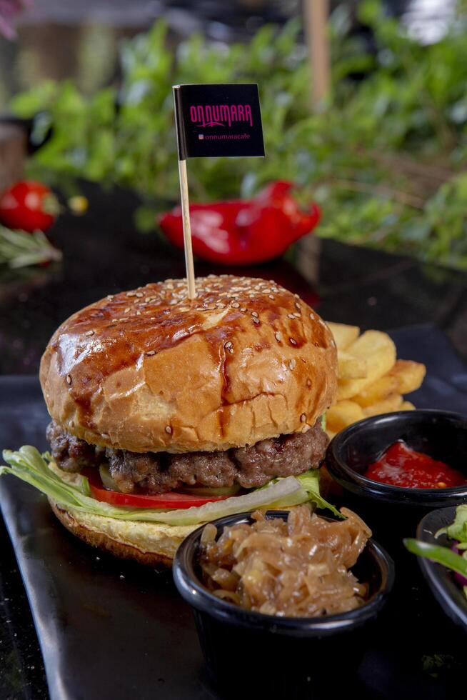 Delicious fresh juicy burger with beef cutlet, cheese, with salads photo
