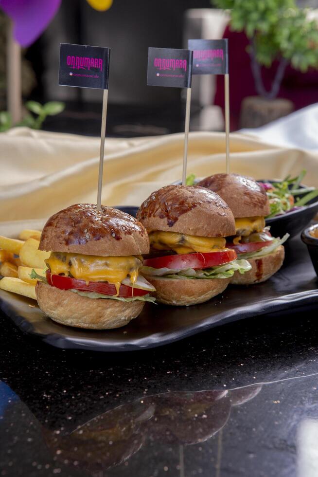 Delicious fresh juicy burger with beef cutlet, cheese, with salads photo