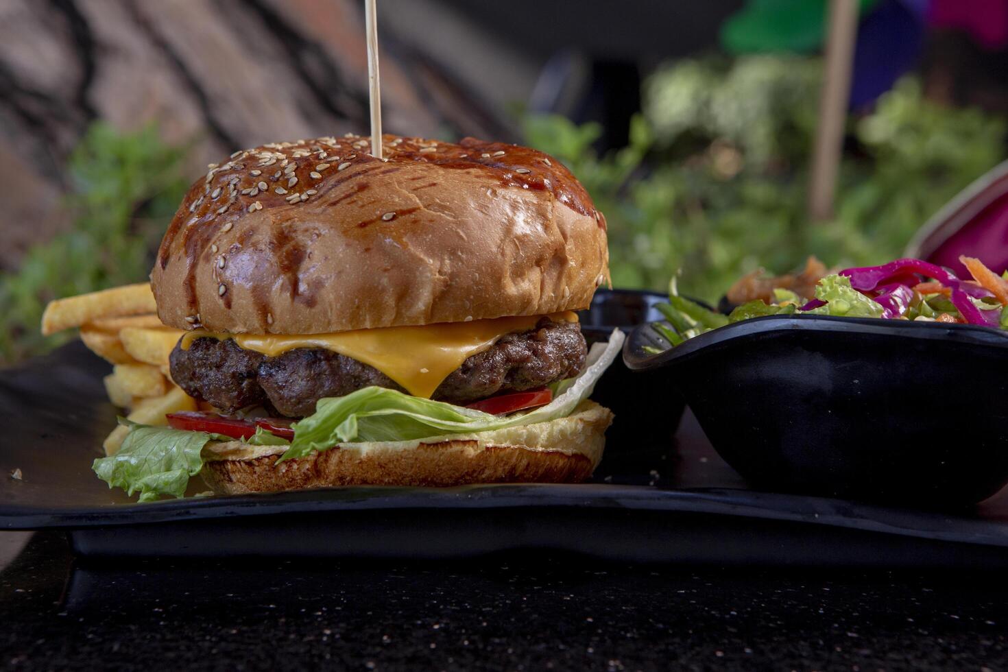 Delicious fresh juicy burger with beef cutlet, cheese, with salads photo