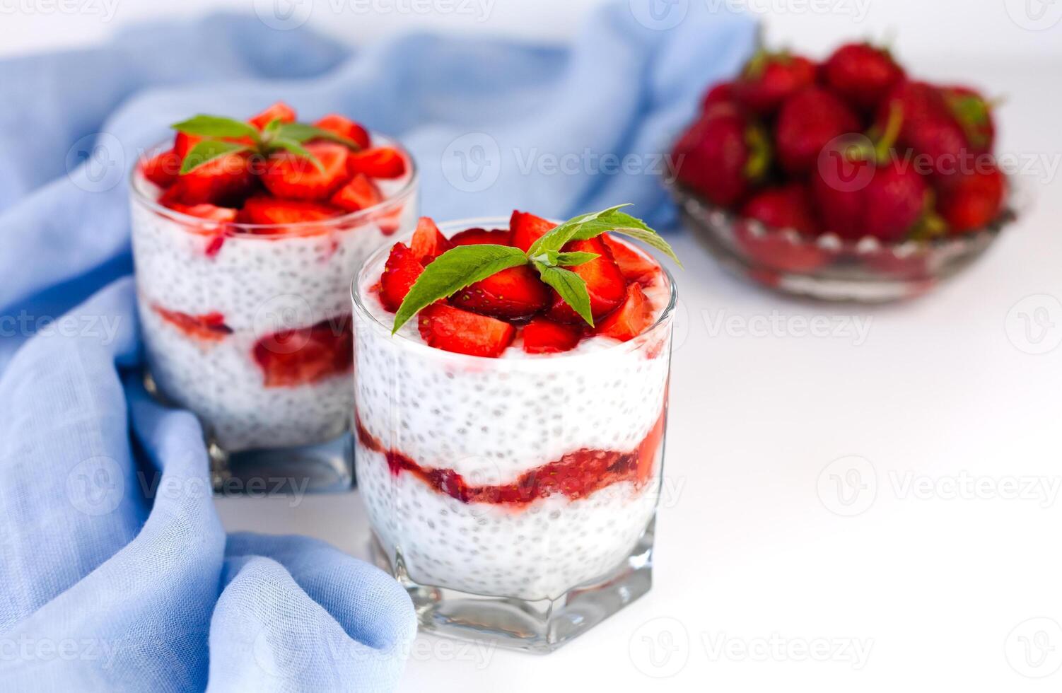 Tasty dessert with fresh strawberry, yogurt and chia seeds on white background. Healthy food concept. Copy space. photo
