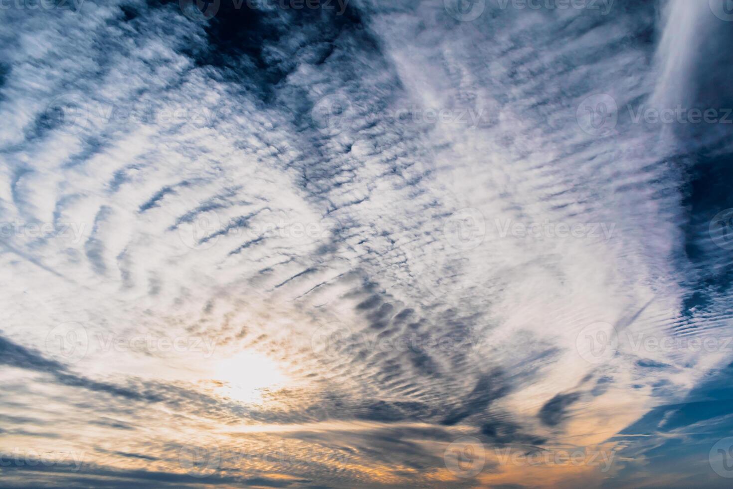 Beautiful striated cloud formation in sky looking like fluffy waves, weather forecast photo