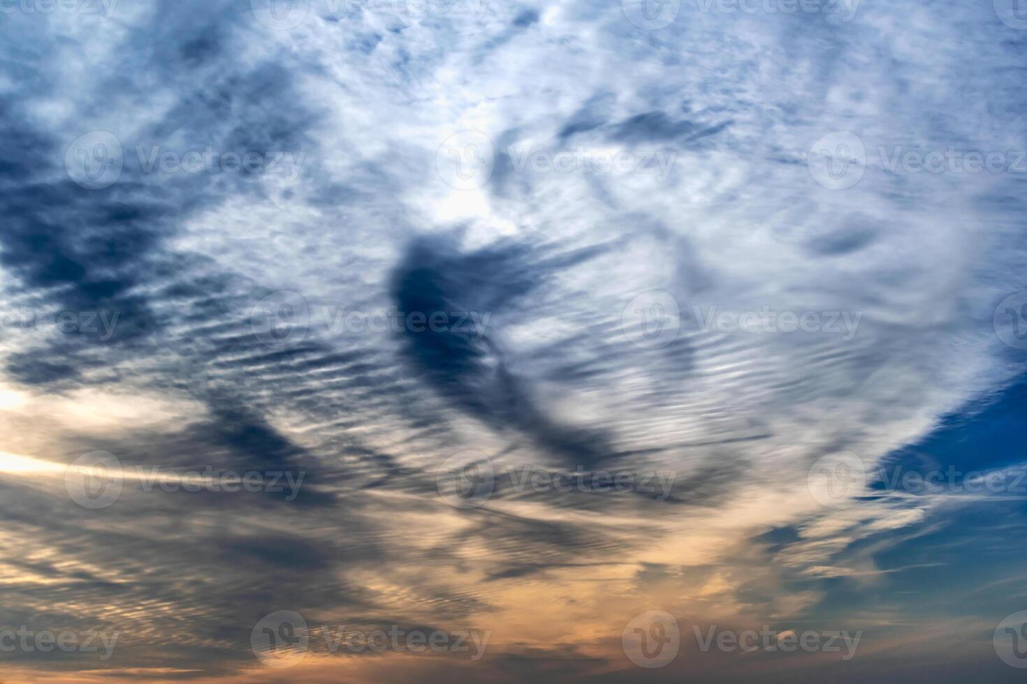 Beautiful striated cloud formation in sky looking like fluffy waves, weather forecast photo