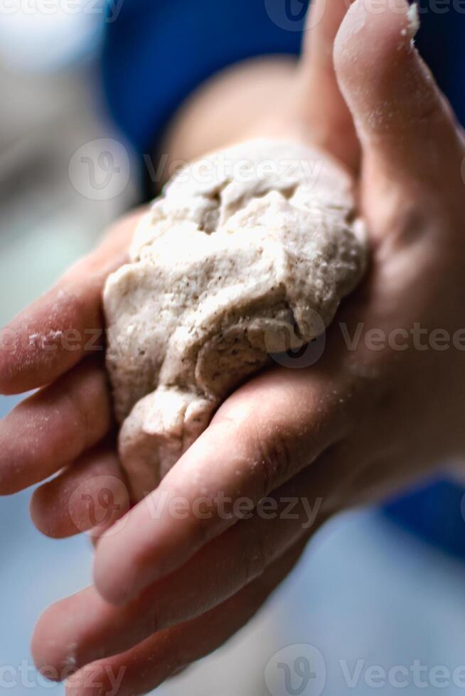 Child having fun modeling dough, authentic activity for fine motor skills development photo