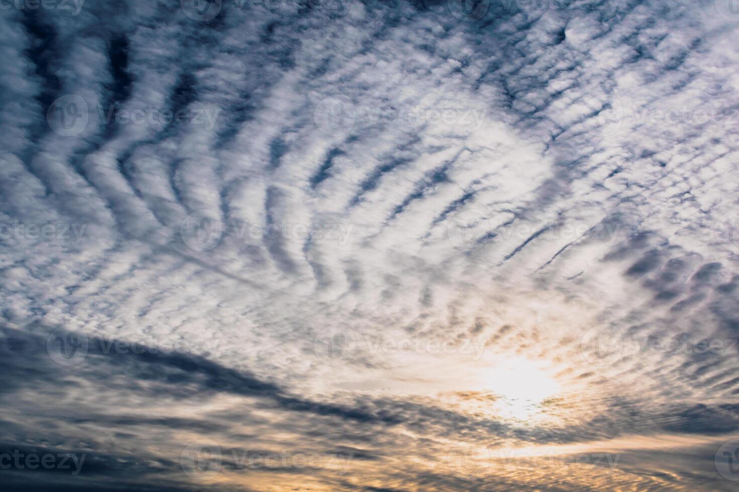 Beautiful striated cloud formation in sky looking like fluffy waves, weather forecast photo