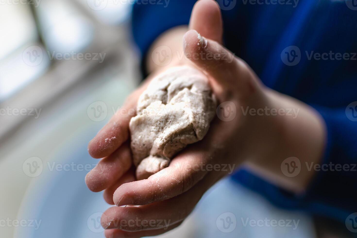 Child having fun modeling dough, authentic activity for fine motor skills development photo