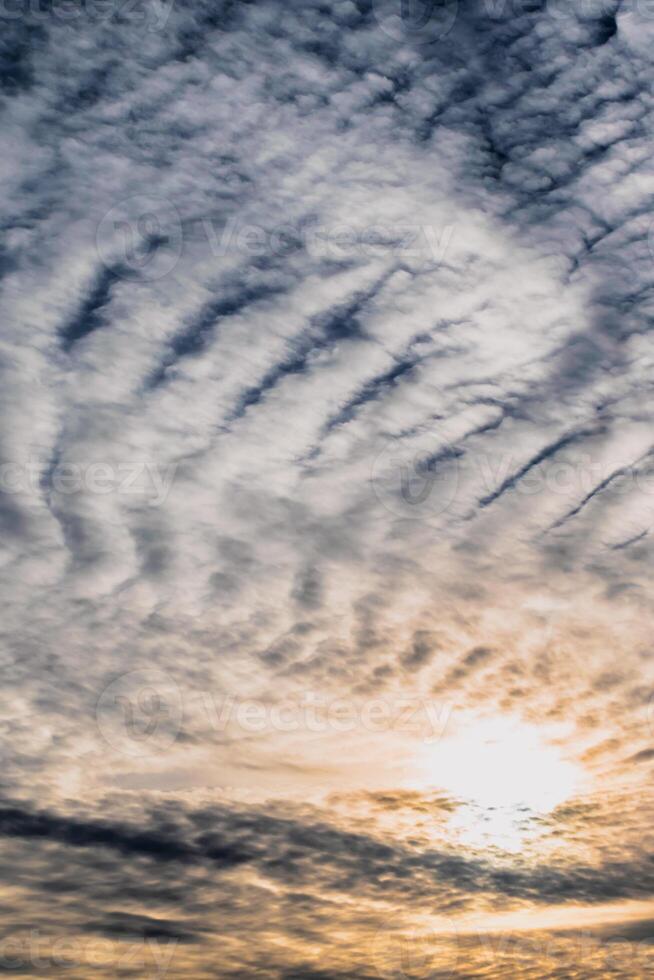 Beautiful striated cloud formation in sky looking like fluffy waves, weather forecast photo