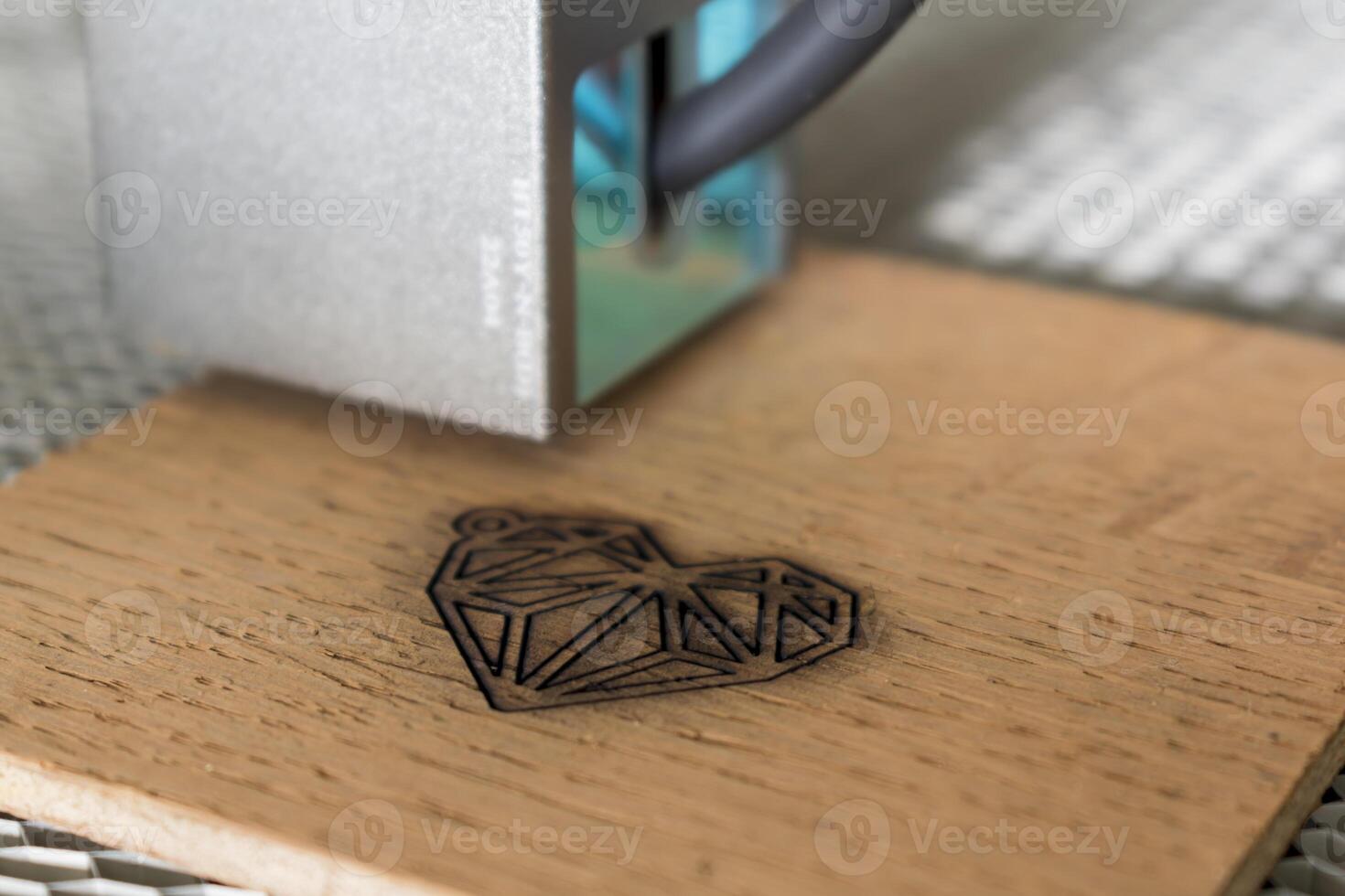 Engraving and cutting laser, example of a heart on a wooden support photo