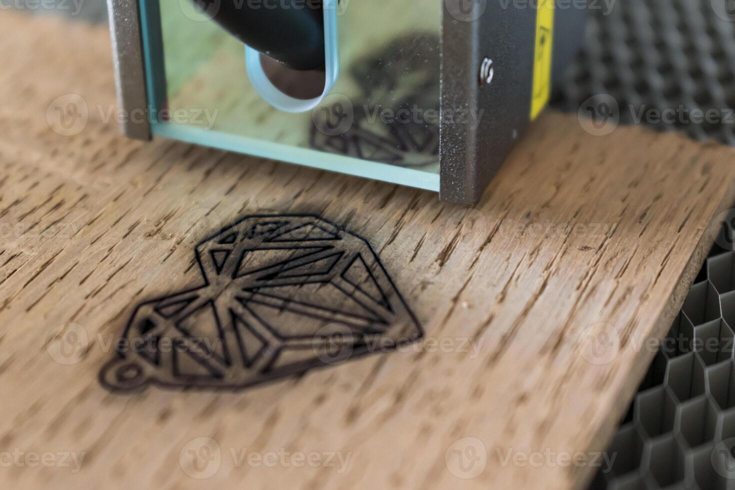 Engraving and cutting laser, example of a heart on a wooden support photo