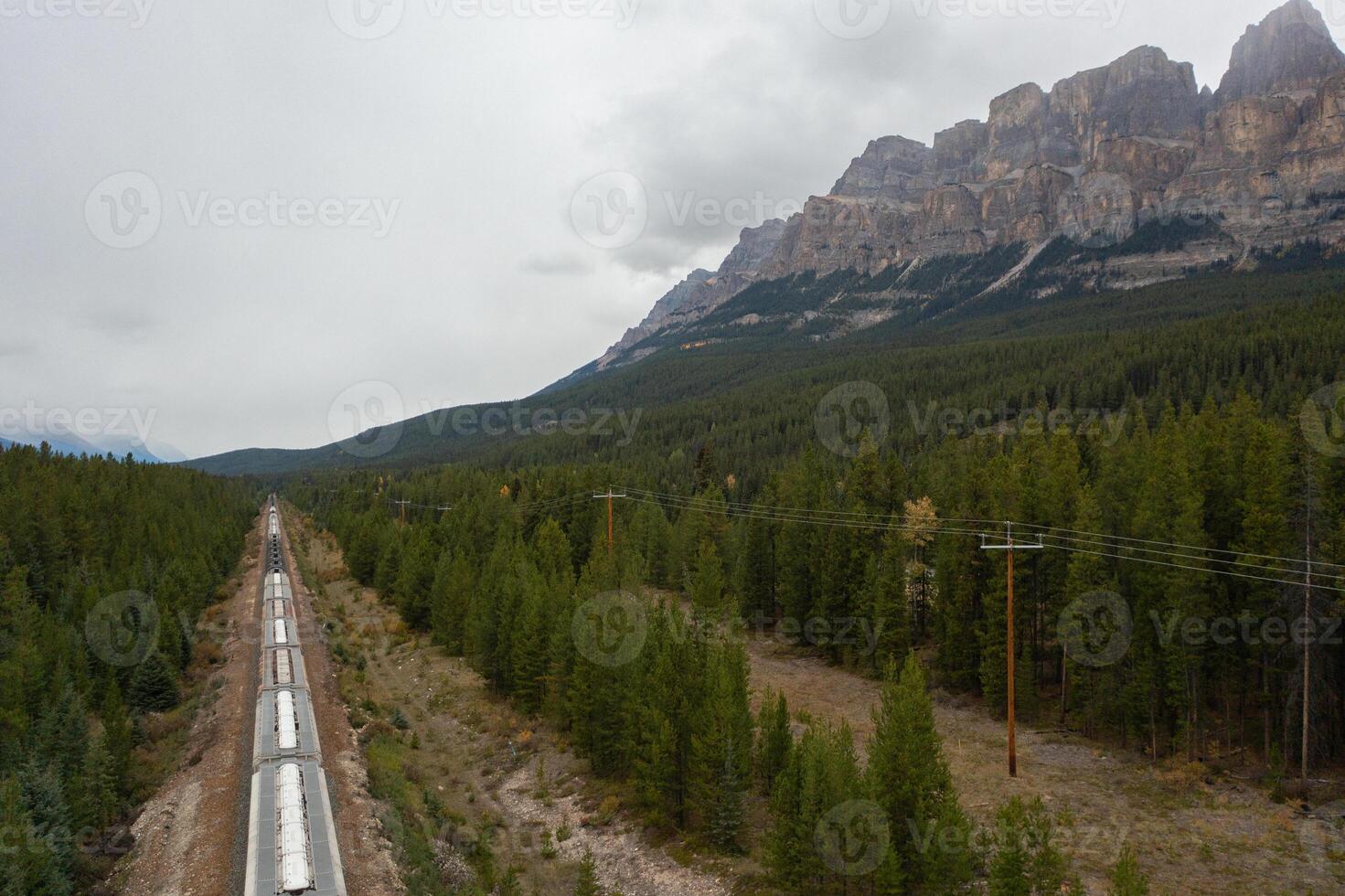 Train tracks crossing the rocky mountains of Canada photo