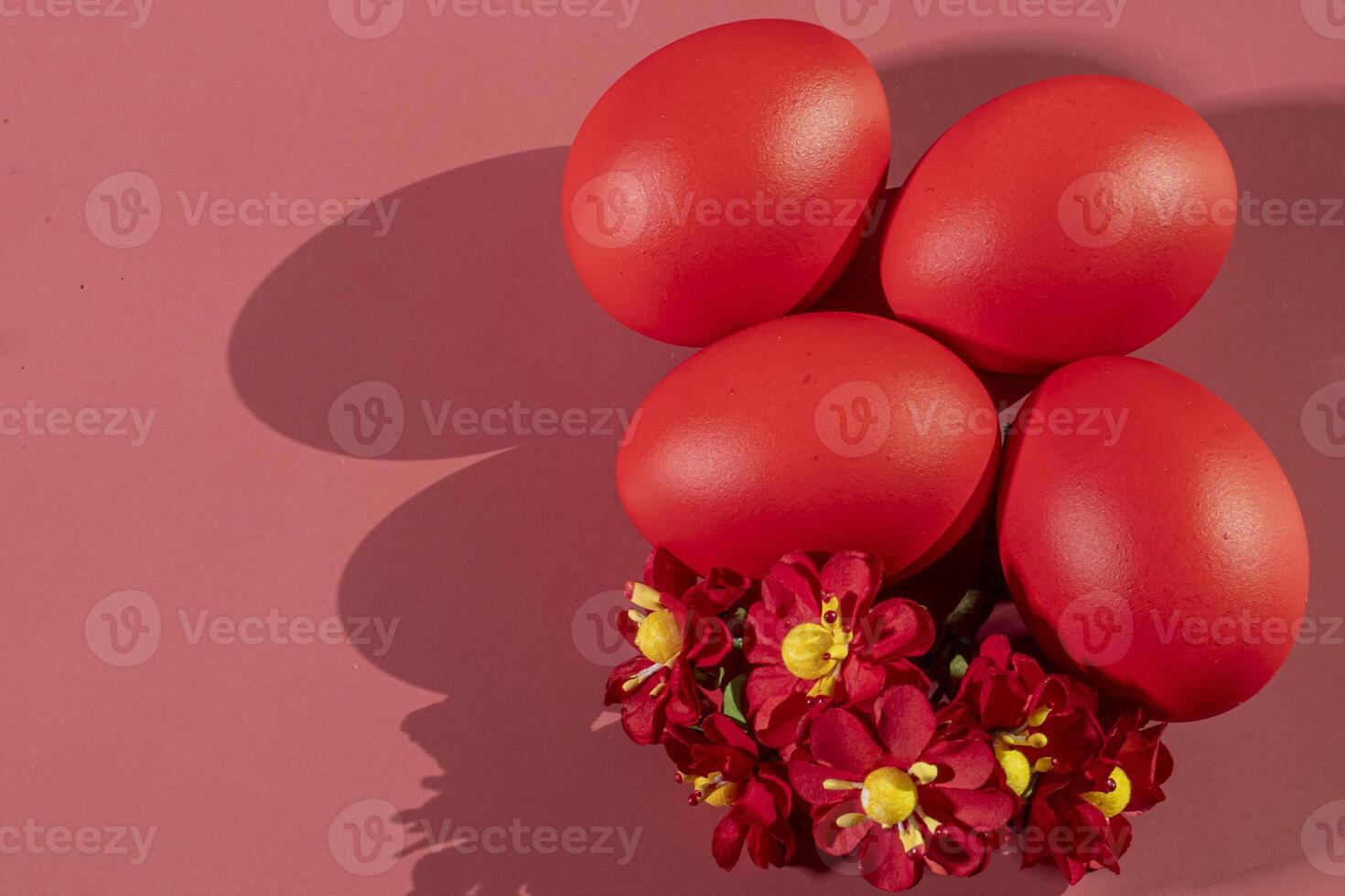 Colorful eggs, symbolizing Easter, on a colorful background and flowers photo