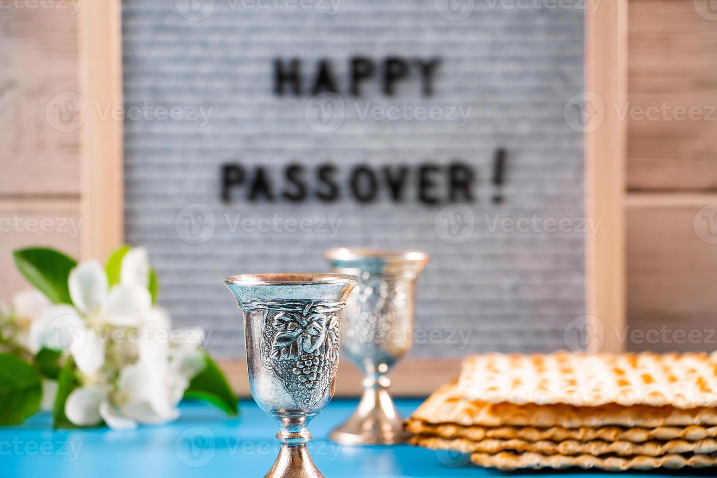 Happy Passover. Metal wine glasses and traditional Jewish matzo bread. photo
