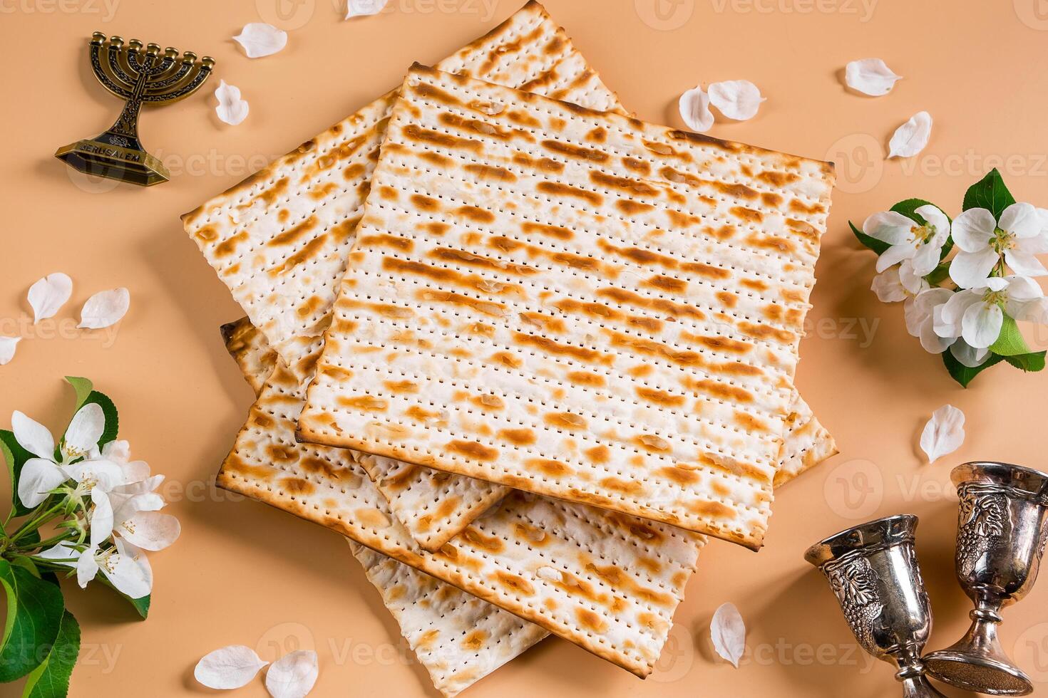 Happy Passover. Traditional Jewish holiday. Silver wine cups, spring flowers and matzo bread photo