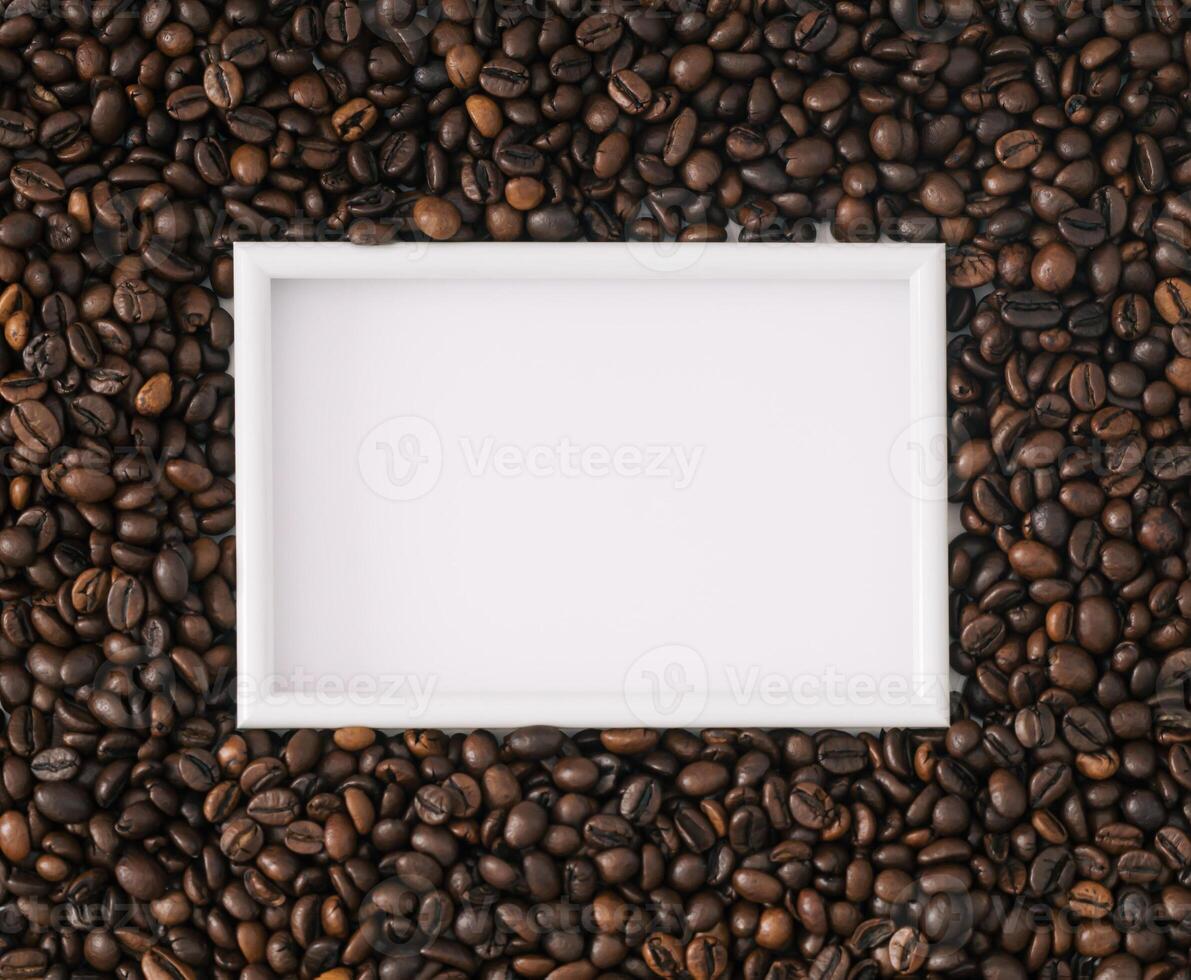 Roasted coffee beans background with white frame copy space. Minimal concept and simplicity. Coffee aesthetic background. Flat lay, top of view. photo