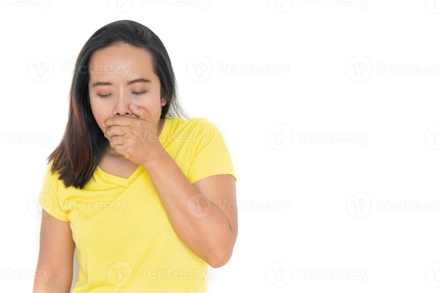 The woman wears a yellow shirt with a cough hand to mouth.Isolated on white. photo