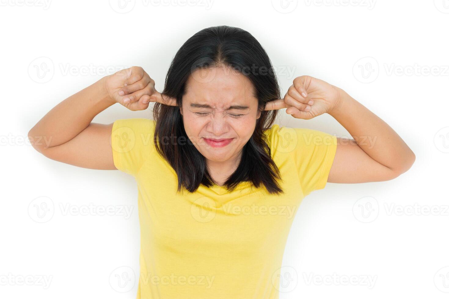 Woman closed her ears because of the annoying noise. isolated on white. photo