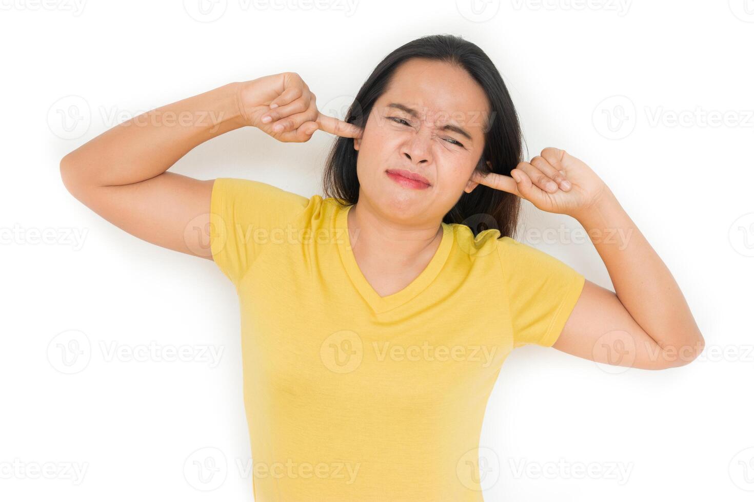 Woman closed her ears because of the annoying noise. isolated on white. photo