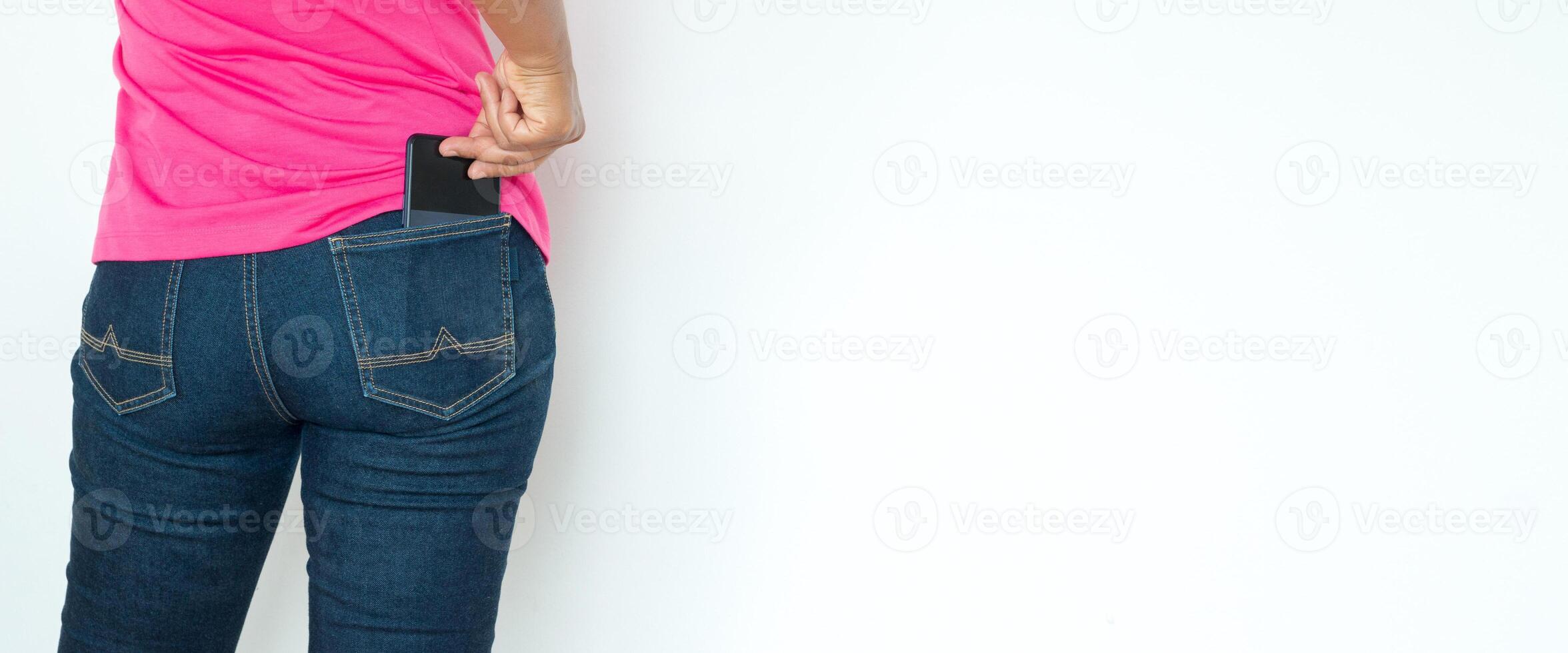 back view of woman with smartphone in jeans . backside view of person. Isolated over white background. photo