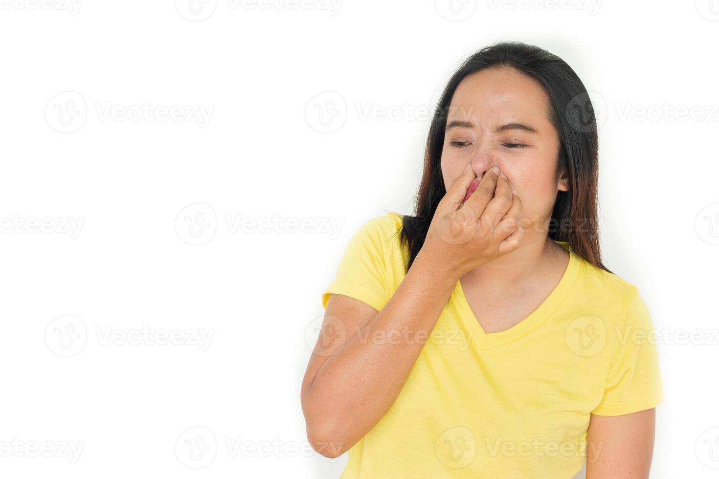 woman holding her nose because of bad smell isolated on a white background photo