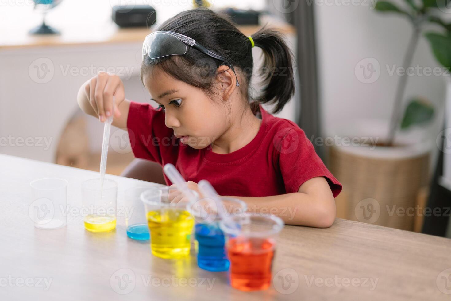 Asian girl doing chemical experiments at the lab photo