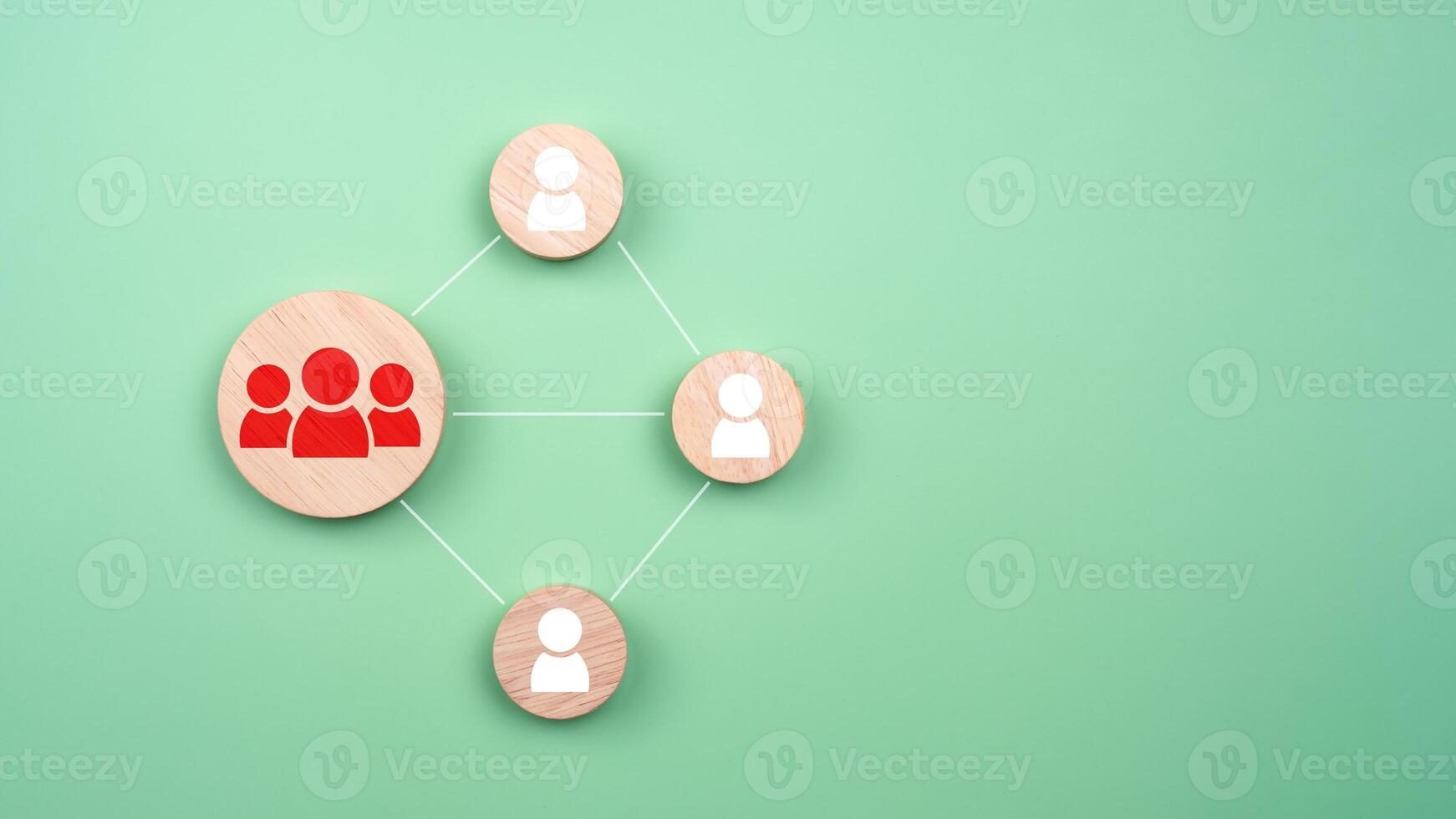 Circular wood with printed target icons and business symbols on green background, business goals and objectives concept, business competition, Customer relationship management concept. photo