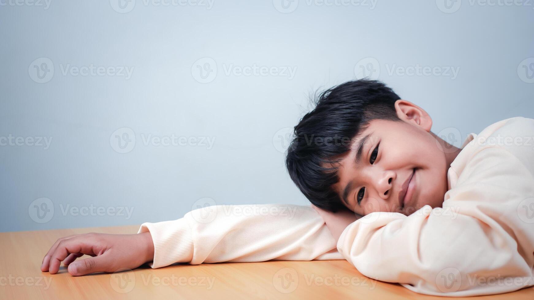 The boy was sitting and thinking about various stories, analyzing and sorting things out. photo