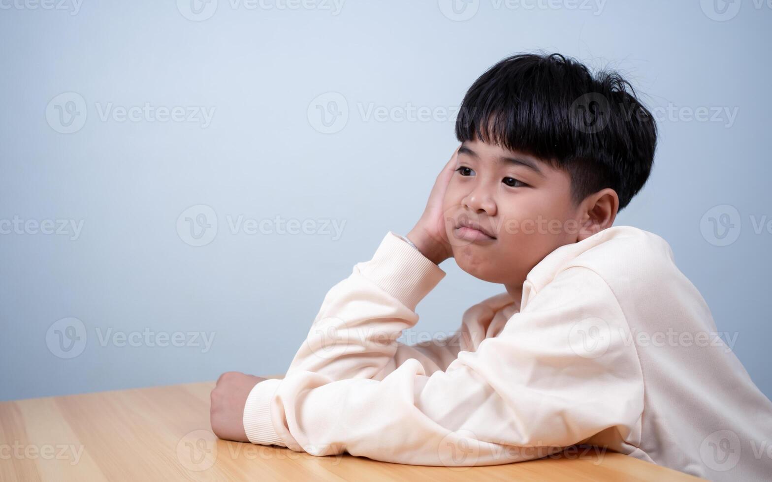 The boy was sitting and thinking about various stories, analyzing and sorting things out. photo