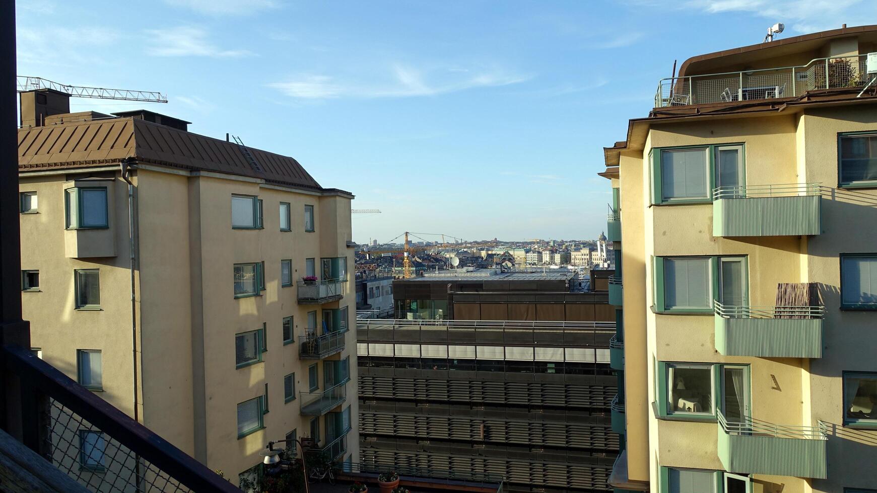 walking in the historic center of Stockholm. You can see the construction site cranes and a hot air balloon. photo